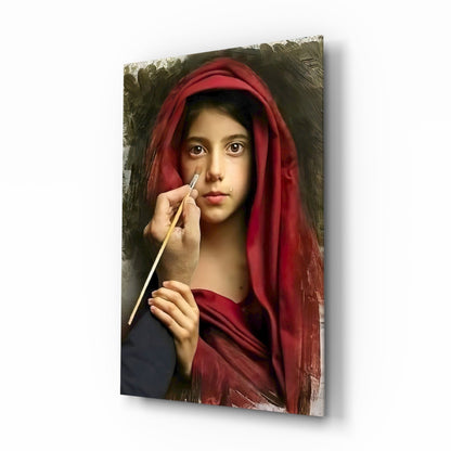 Young person wearing a crimson red head covering and dark garment, holding a paintbrush to their face, against a muted olive-toned background on glass wall art.