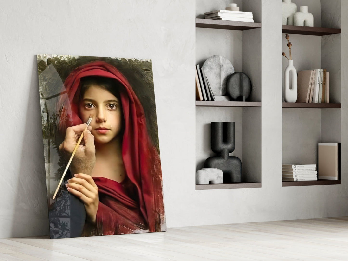 Portrait glass wall art leaning against white wall displays young woman in red headscarf holding paintbrush beside modern shelving.