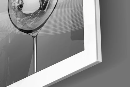 Close-up angled view of a clear glass goblet with etched horizontal line patterns mounted on a white wall frame against gray background.