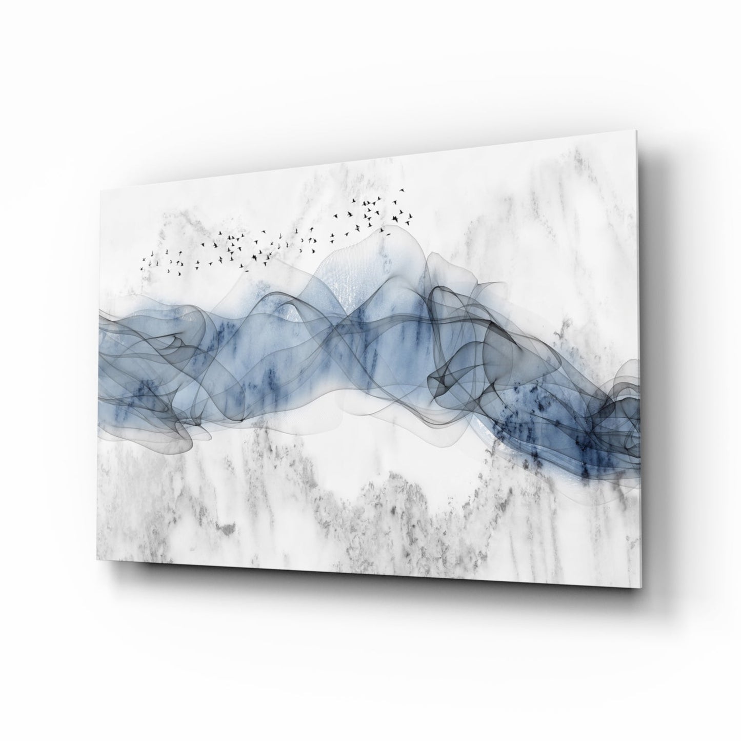 Angled product view of blue fog glass wall art showing translucent layered blue forms with birds and textured gray background on white surface.