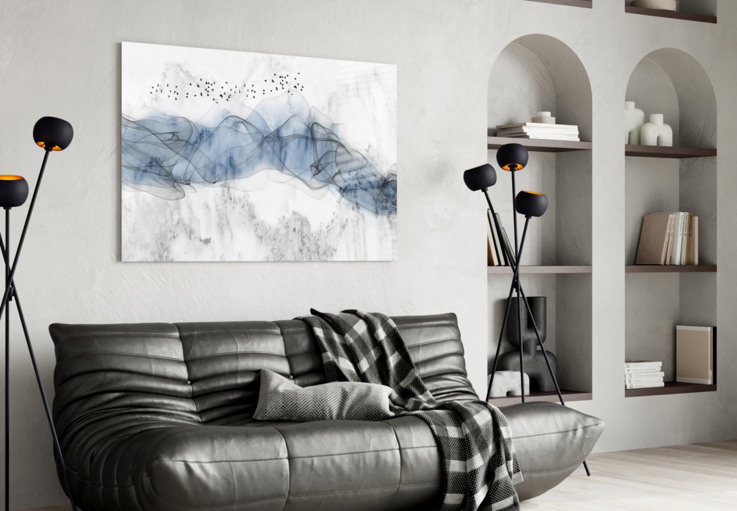Blue Fog glass wall art with abstract blue and gray flowing patterns and birds displayed above black leather sofa in modern living room setting.