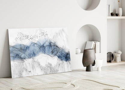 Blue Fog Glass Wall Art leaning against white wall in minimalist room with sand, ceramics, and built-in shelving.
