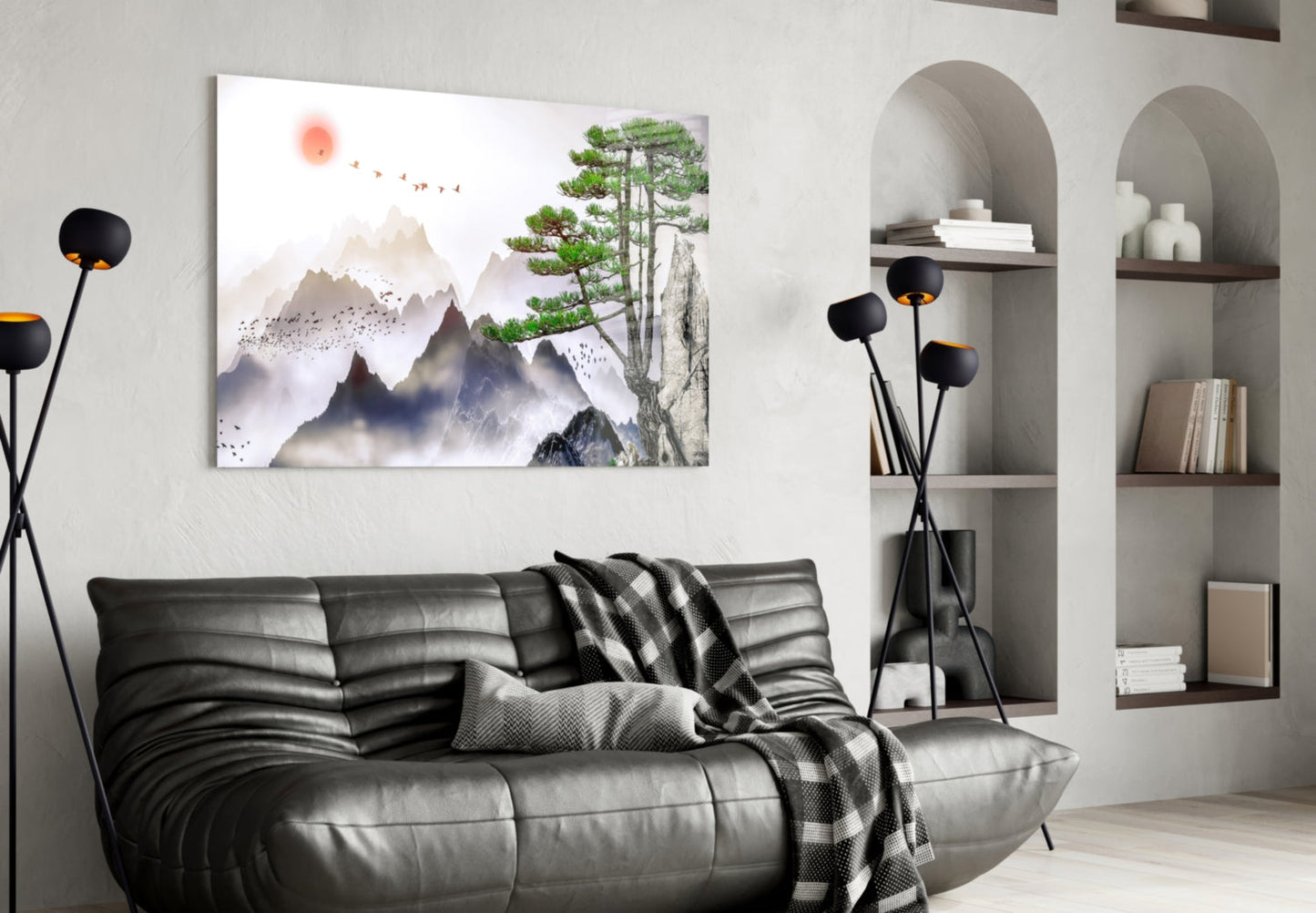 Modern living room with misty mountain landscape glass art above black leather sofa and decorative floor lamp.
