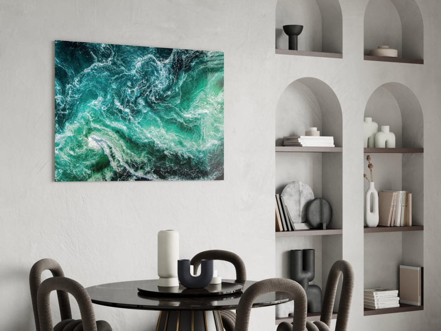 Green Waves glass wall art displayed above a black dining table in a modern interior with white built-in shelving.