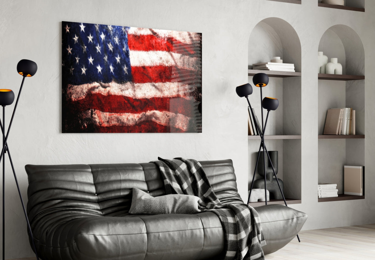 Distressed American flag glass wall art displayed above a black leather sofa in a modern living room interior.