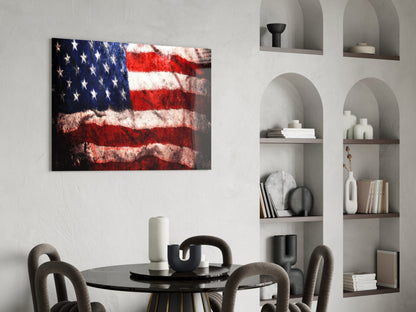 Distressed American flag glass wall art displayed above a black round dining table with gray chairs in a modern interior.