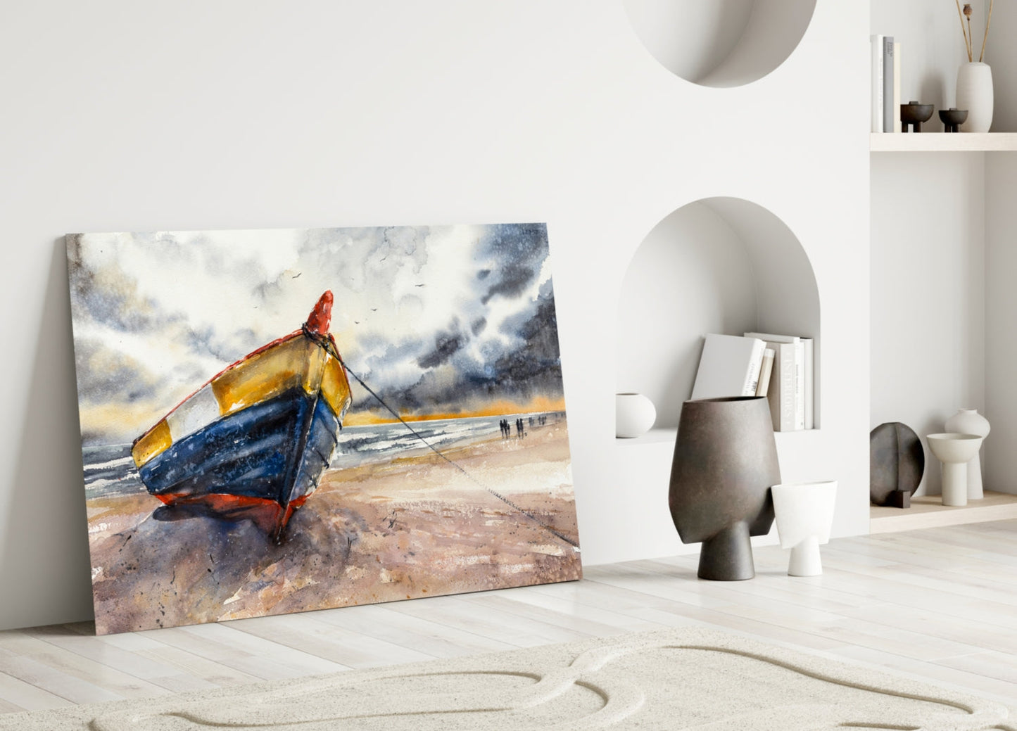 Solo Canoe Glass Wall Art leaning against white wall displaying colorful fishing boat on beach with stormy sky, displayed in minimalist interior setting.