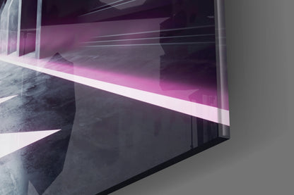 Angled view of glass wall art panel displaying magenta neon light against dark concrete interior architectural setting.