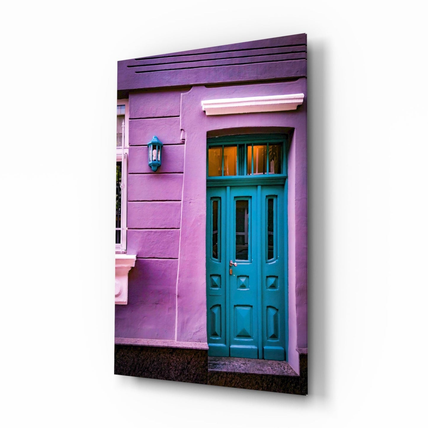 Vibrant purple facade with turquoise-blue double doors and decorative wall-mounted lantern displayed as glass wall art.