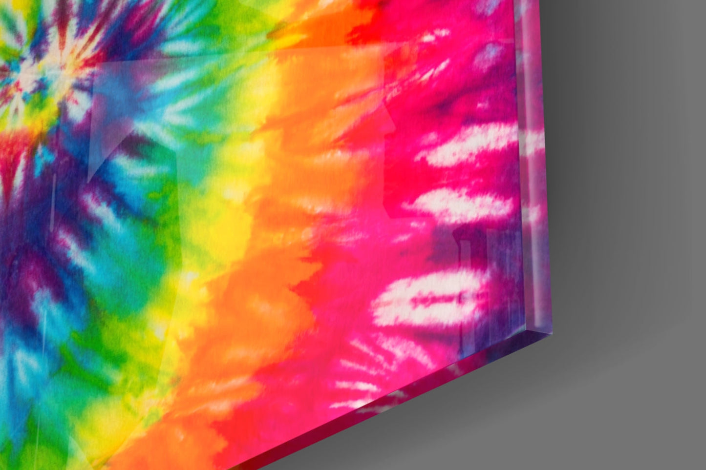 Angled perspective of rainbow tie-dye glass panel showing vibrant color gradients from blue-green to yellow-orange-pink with white streaks.