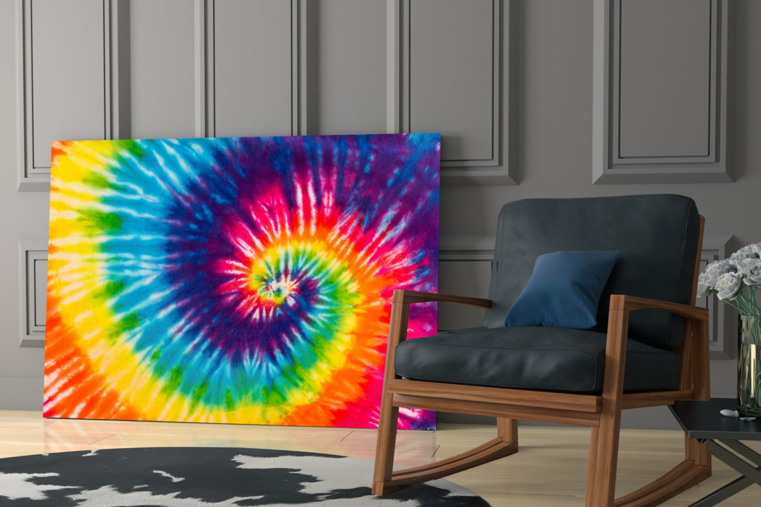Vibrant rainbow tie-dye glass wall art displayed in a modern living room next to a wooden rocking chair.