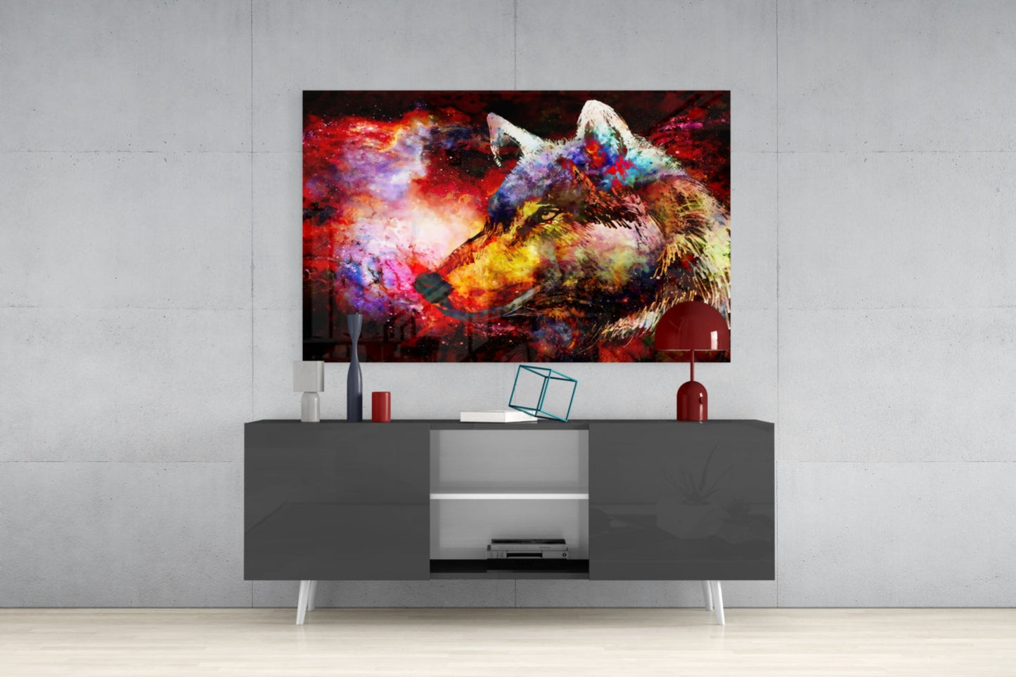 Colorful wolf glass wall art displaying vibrant reds, blues, and yellows mounted above gray media console in modern living room setting.