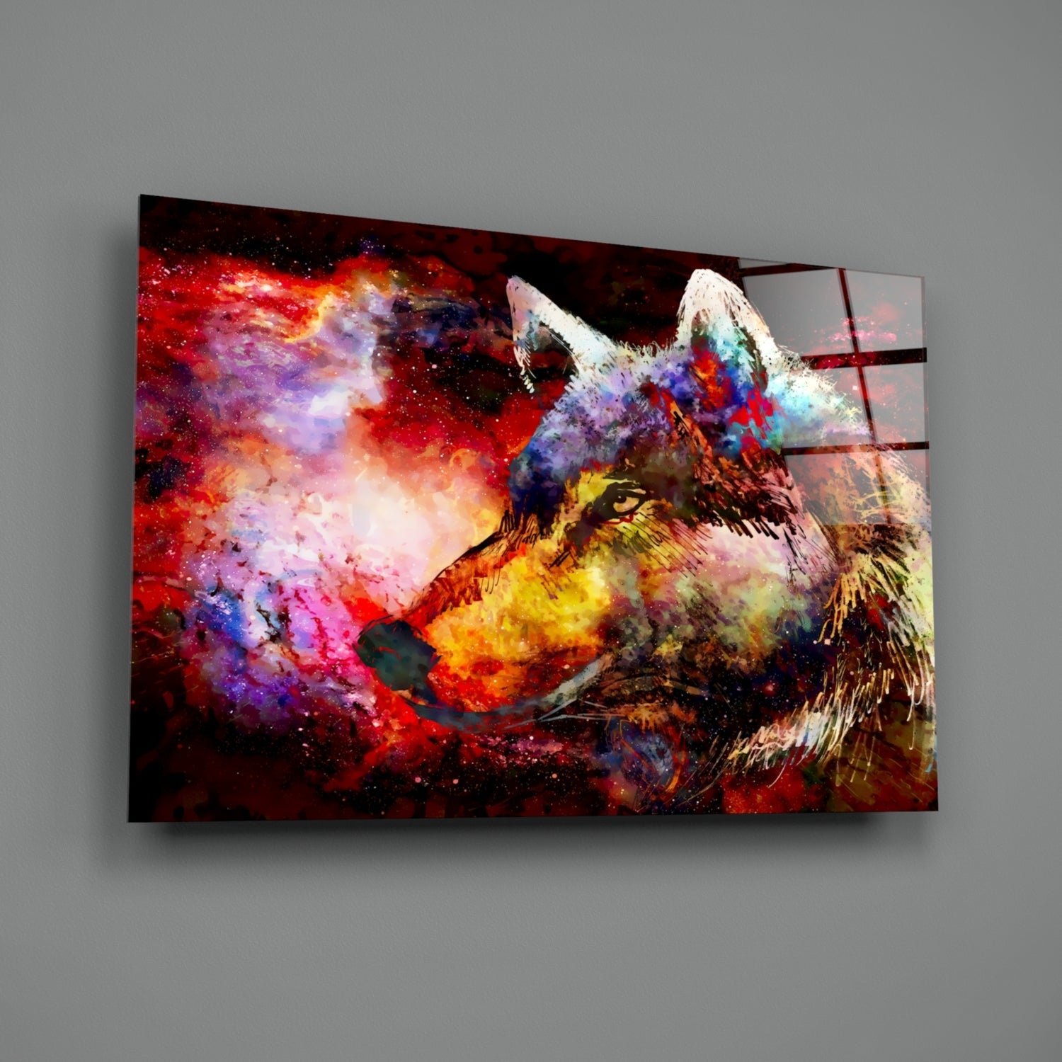 Colorful wolf glass wall art mounted on gray wall, displaying vibrant red, purple, yellow, and blue abstract painted wolf head against dark background.