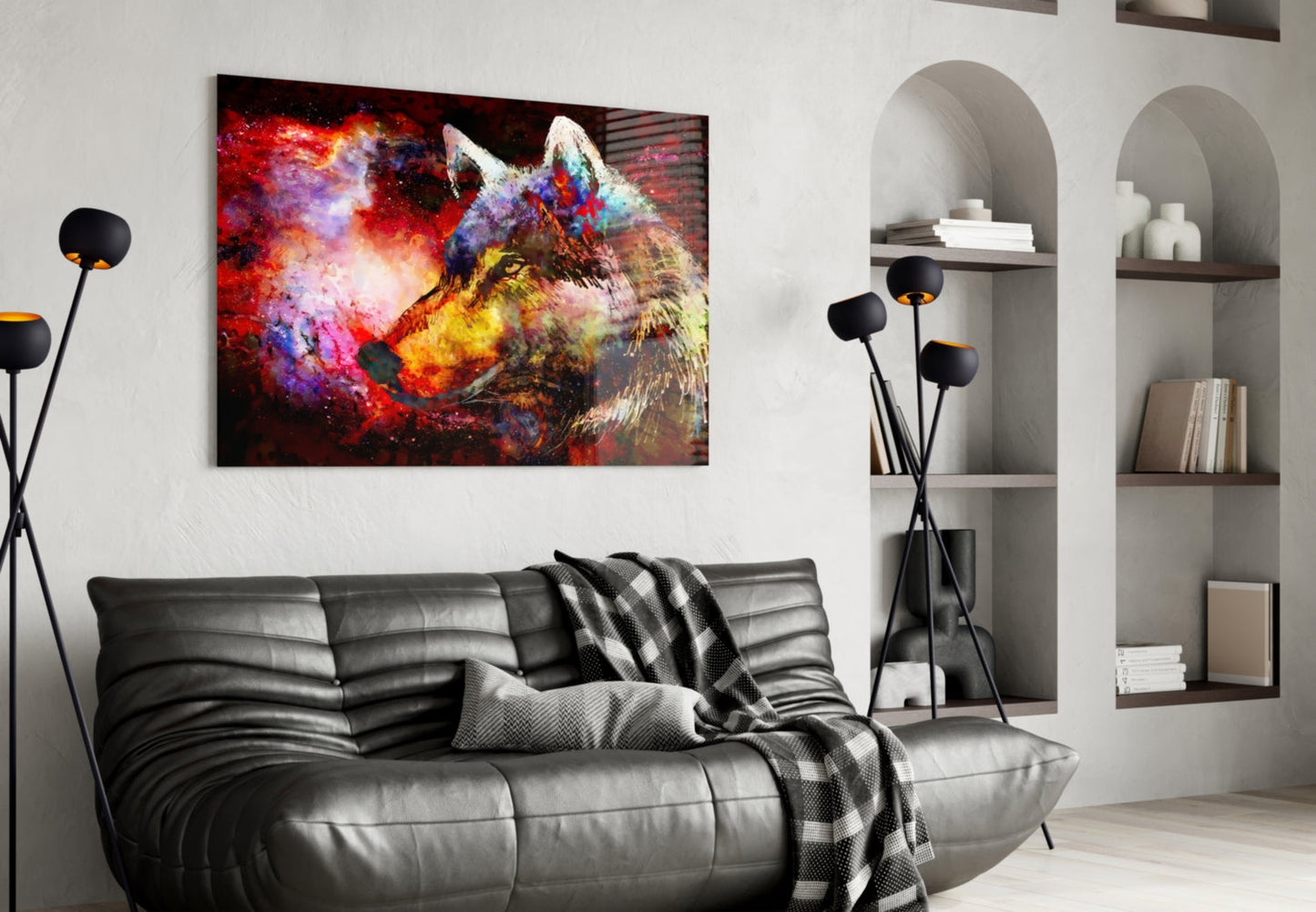 Colorful wolf glass wall art hanging above black leather sofa in modern living room with white shelving.