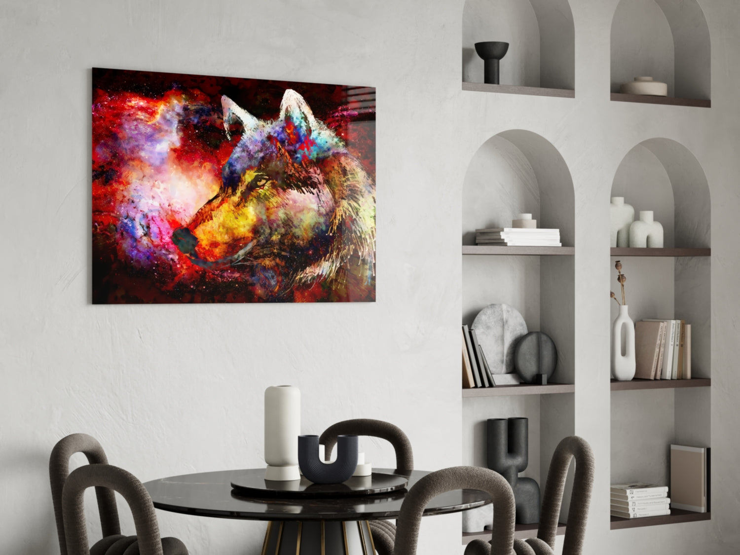 Colorful wolf glass wall art displaying vibrant red, purple, and yellow paint splatter effects hanging above a round black dining table.
