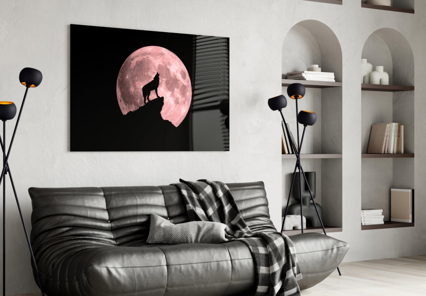 Modern living room interior featuring a black framed glass wall art displaying a silhouetted wolf howling before a large pink full moon.