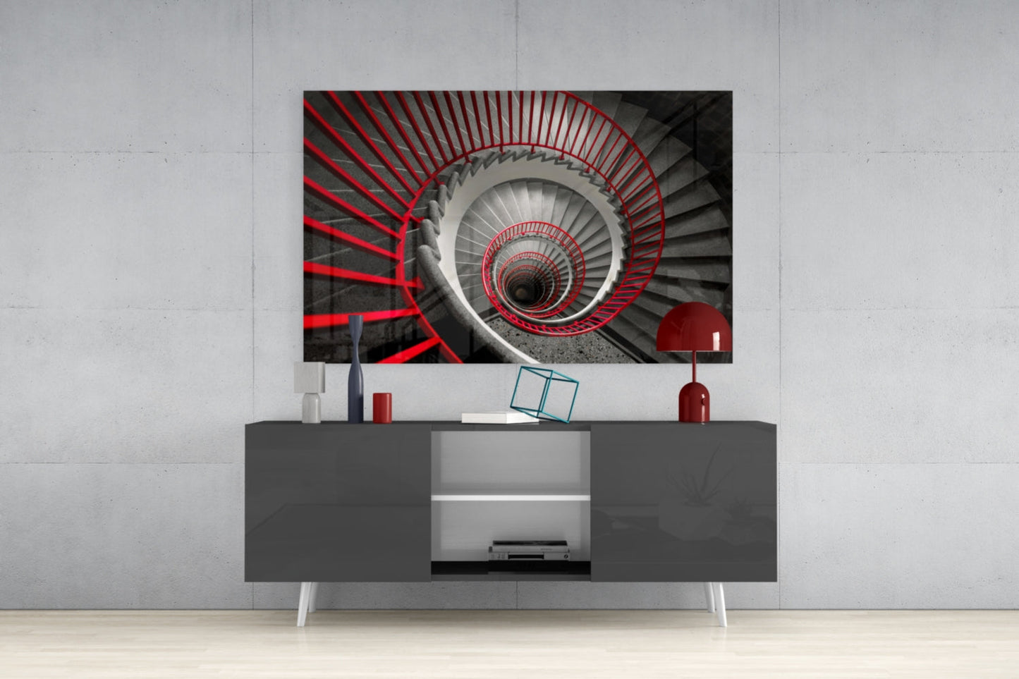 Red and gray spiral staircase glass wall art displayed above gray media console in modern interior setting.