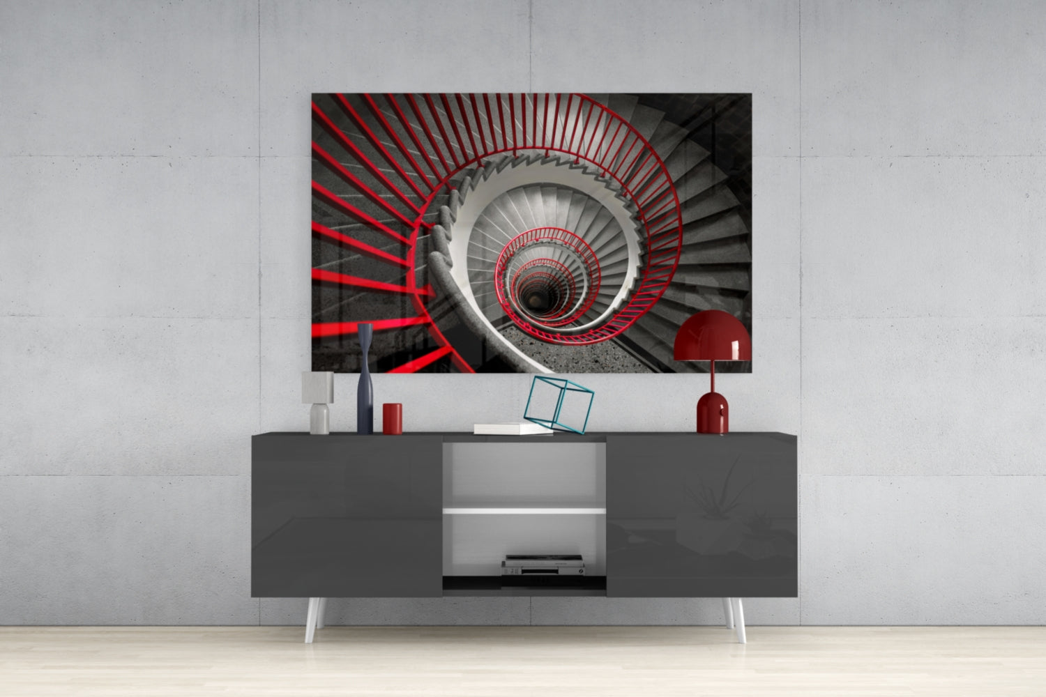 Red and gray spiral staircase glass wall art displayed above gray media console in modern interior setting.