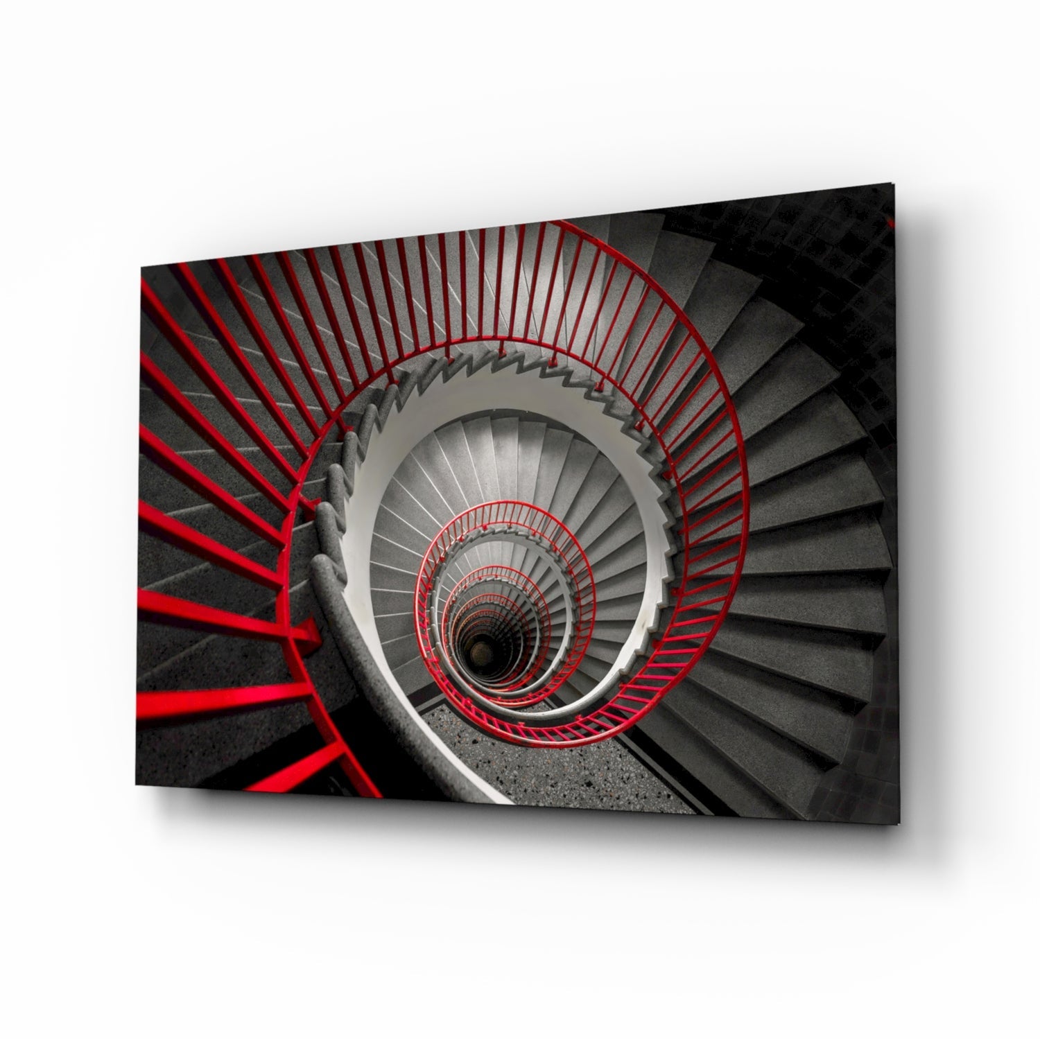 Aerial view of a spiral staircase with red railings descending into darkness, rendered in grayscale with red accents.