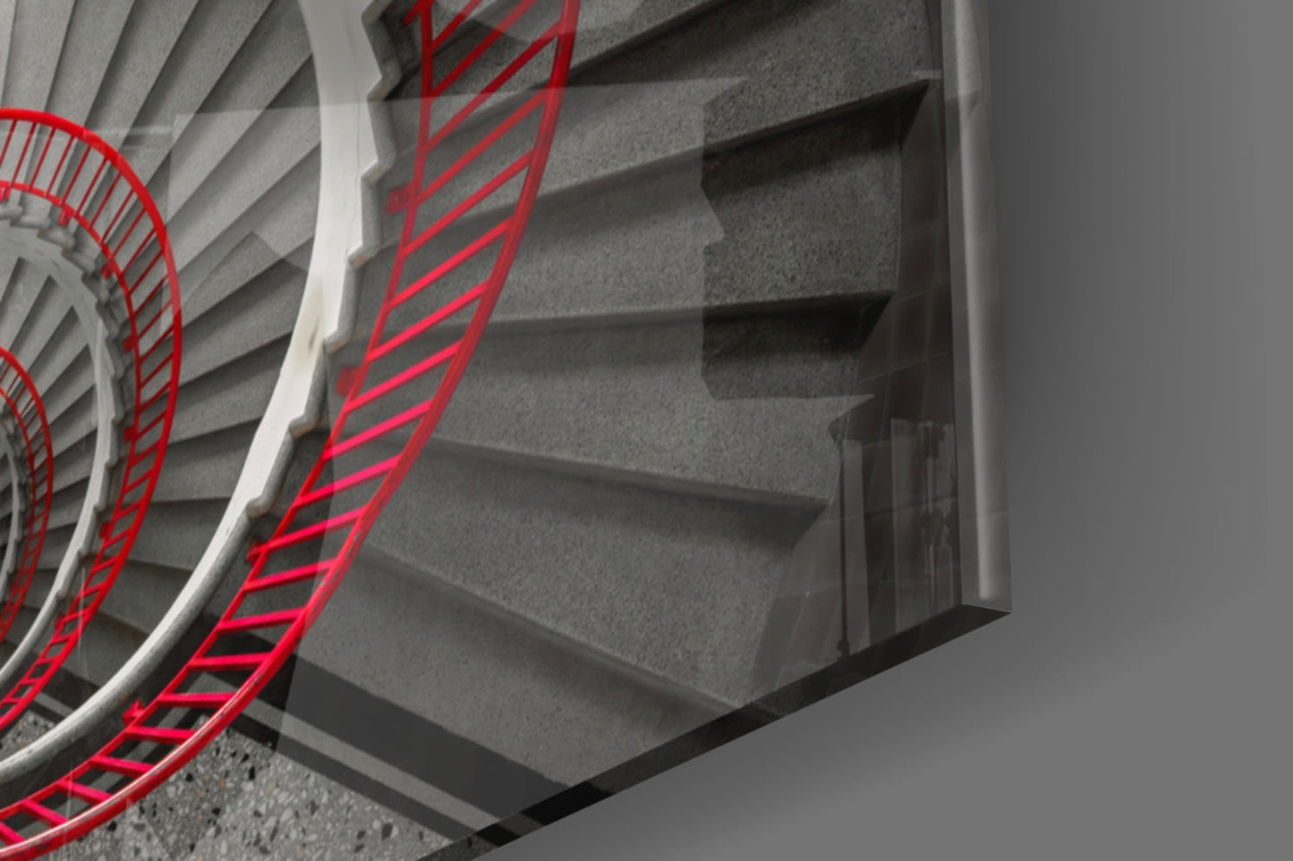 Red stair railing with bright neon lines installed alongside concrete steps viewed from above at an angle.