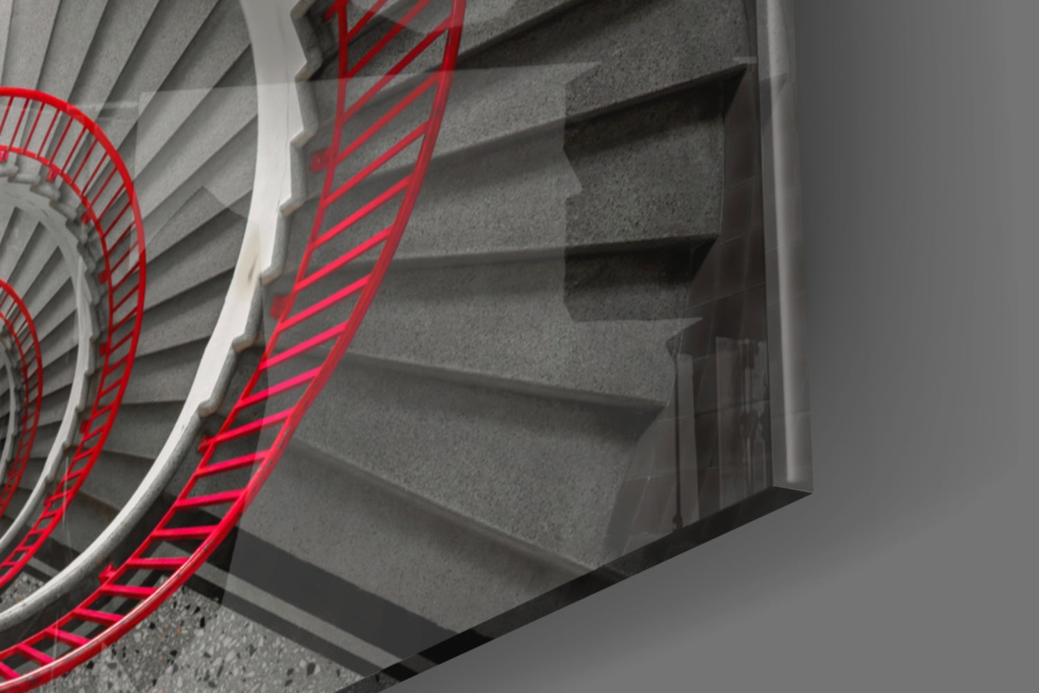 Red stair railing with bright neon lines installed alongside concrete steps viewed from above at an angle.