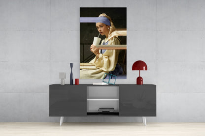 Girl with a Pearl Earring glass wall art displayed above a dark gray console table with decorative objects and open shelving.