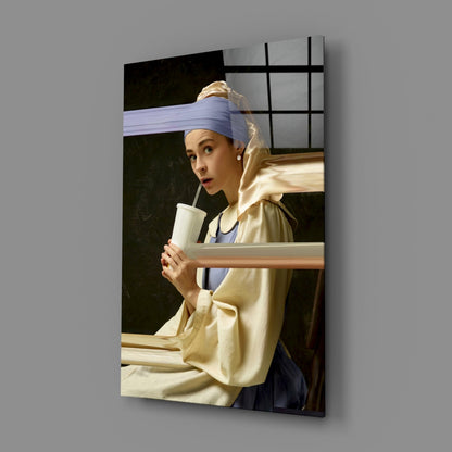 Angled view of Girl with a Pearl Earring glass wall art mounted on gray wall, showing printed artwork with black grid overlay.