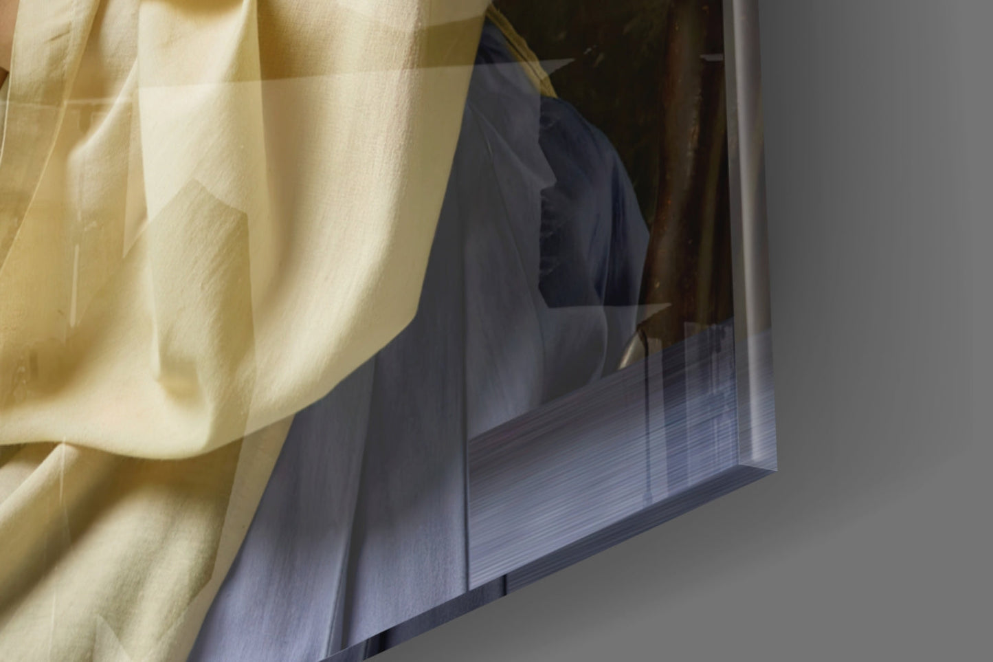 Cream-colored sheer curtain partially obscuring blue glass art panel mounted on white wall, angled view.