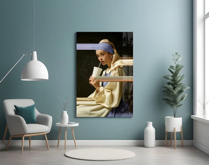 Glass art print of Girl with a Pearl Earring mounted on turquoise wall in modern living room setting with white furniture.