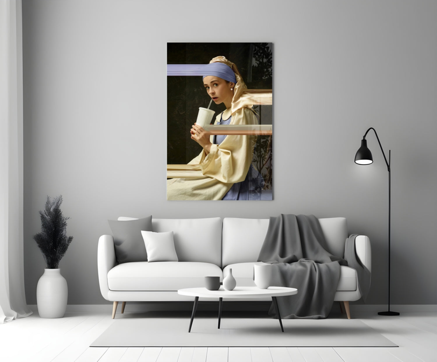 Girl with a Pearl Earring glass wall art displayed above a white sofa in a minimalist living room setting.