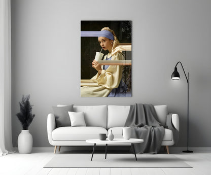 Girl with a Pearl Earring glass wall art displayed above a white sofa in a minimalist living room setting.