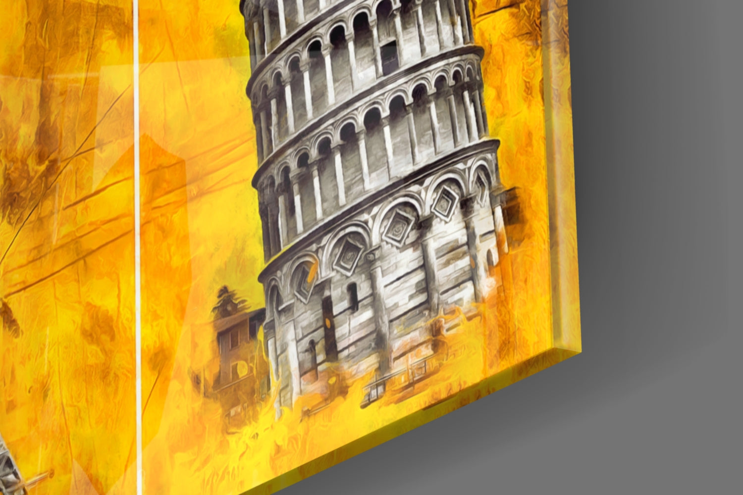 Angled side view of glass wall art displaying the Leaning Tower of Pisa against a vibrant yellow background.