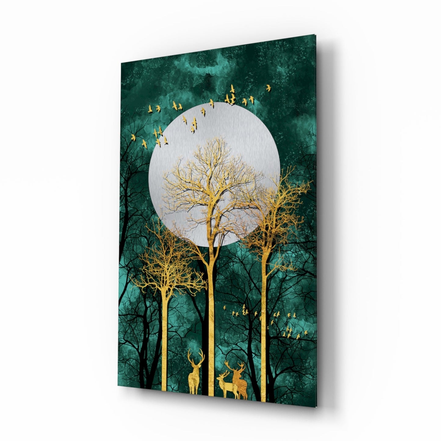 Angled view of teal glass wall art featuring gold trees, deer, flying birds, and a white moon against dark green background.