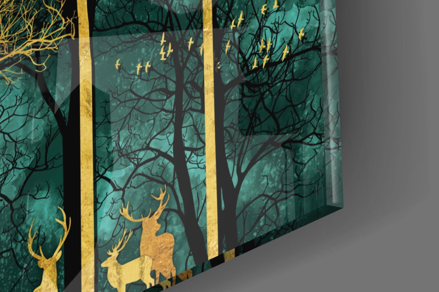 Three-panel glass wall art displaying gold deer silhouettes against a teal forest background with black bare trees.