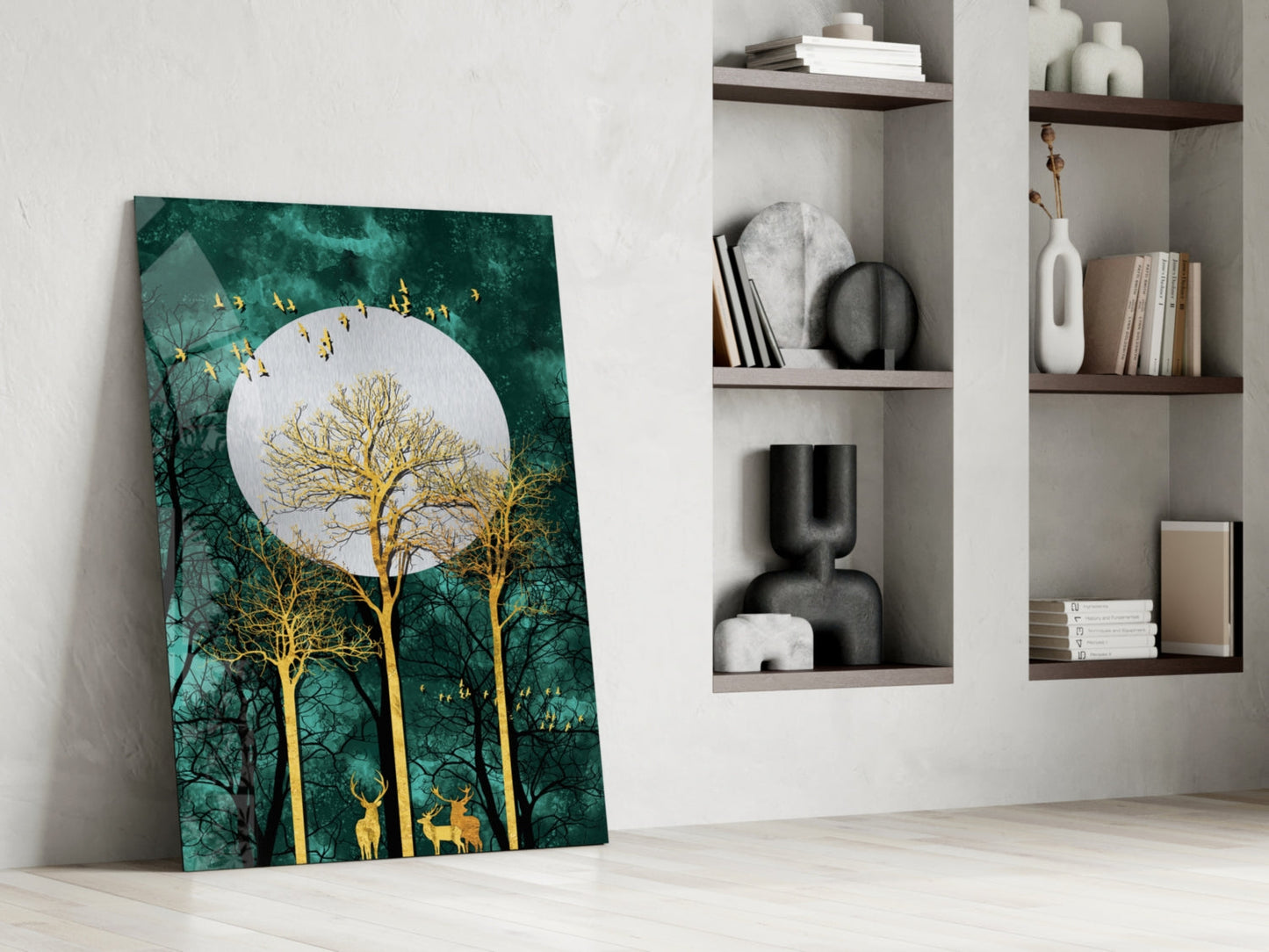 Night Glass Wall Art leaning against white wall beside shelving unit, featuring golden trees and deer beneath white moon on teal background.