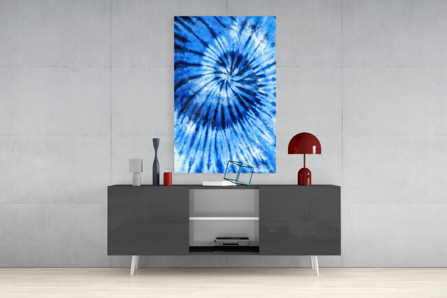Blue tie-dye glass wall art displayed above a gray media console in a modern living room setting.
