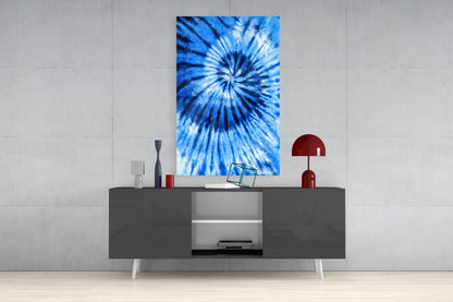 Blue tie-dye glass wall art displayed above a gray media console in a modern living room setting.