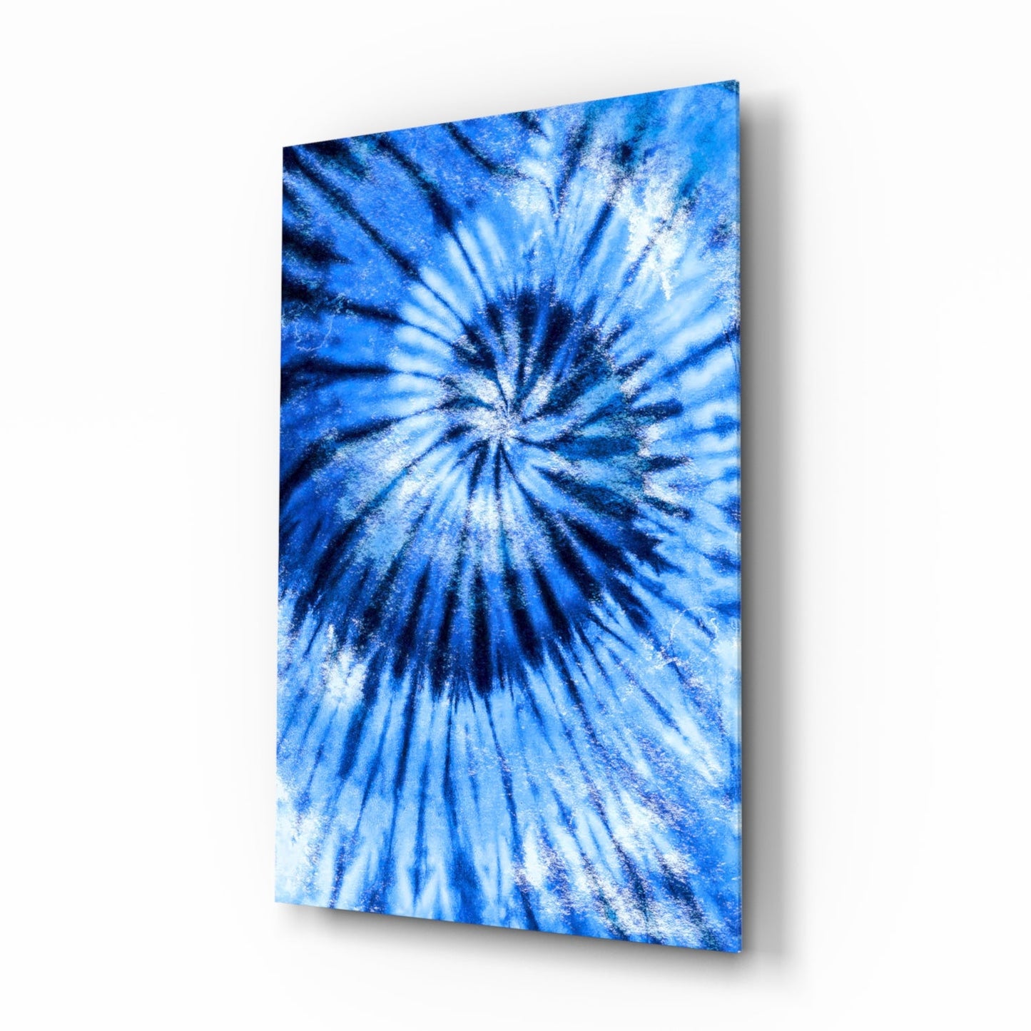 Blue mosaic glass wall art panel displaying radial sunburst pattern with white and navy streaks on angled display.