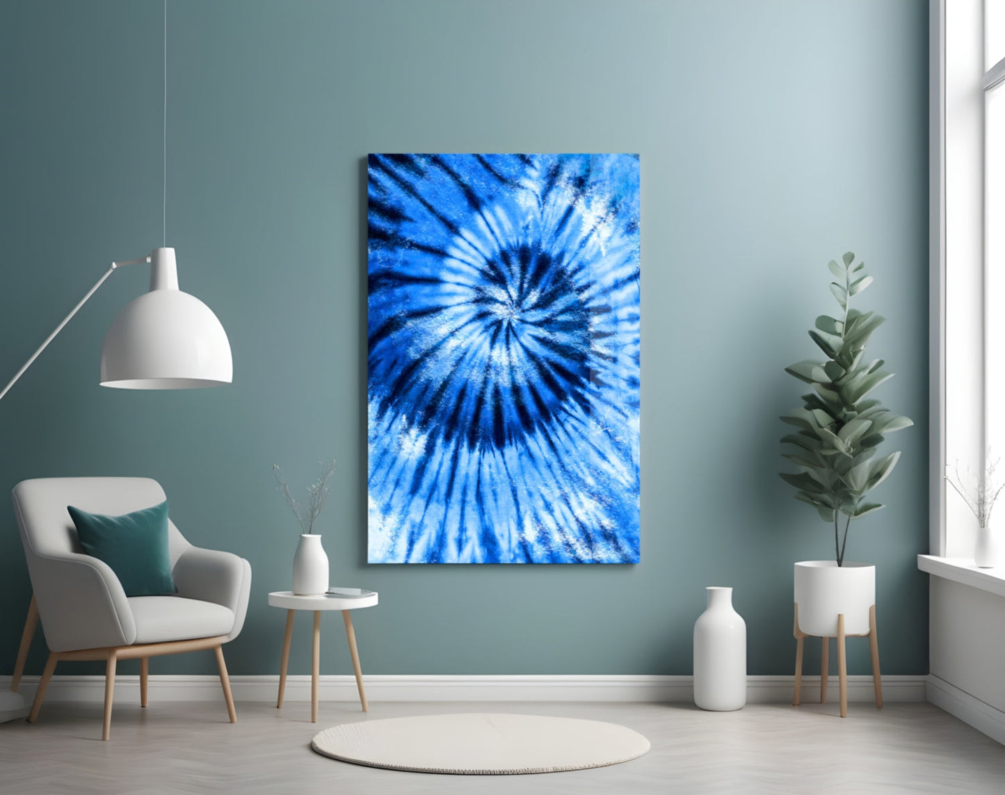 Blue mosaic glass wall art with radial starburst pattern displayed in minimalist room setting with chair and plants.