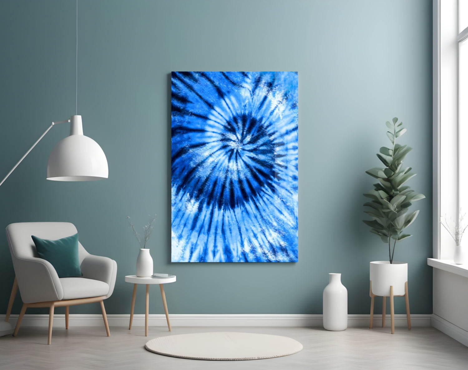 Blue mosaic glass wall art with radial starburst pattern displayed in minimalist room setting with chair and plants.