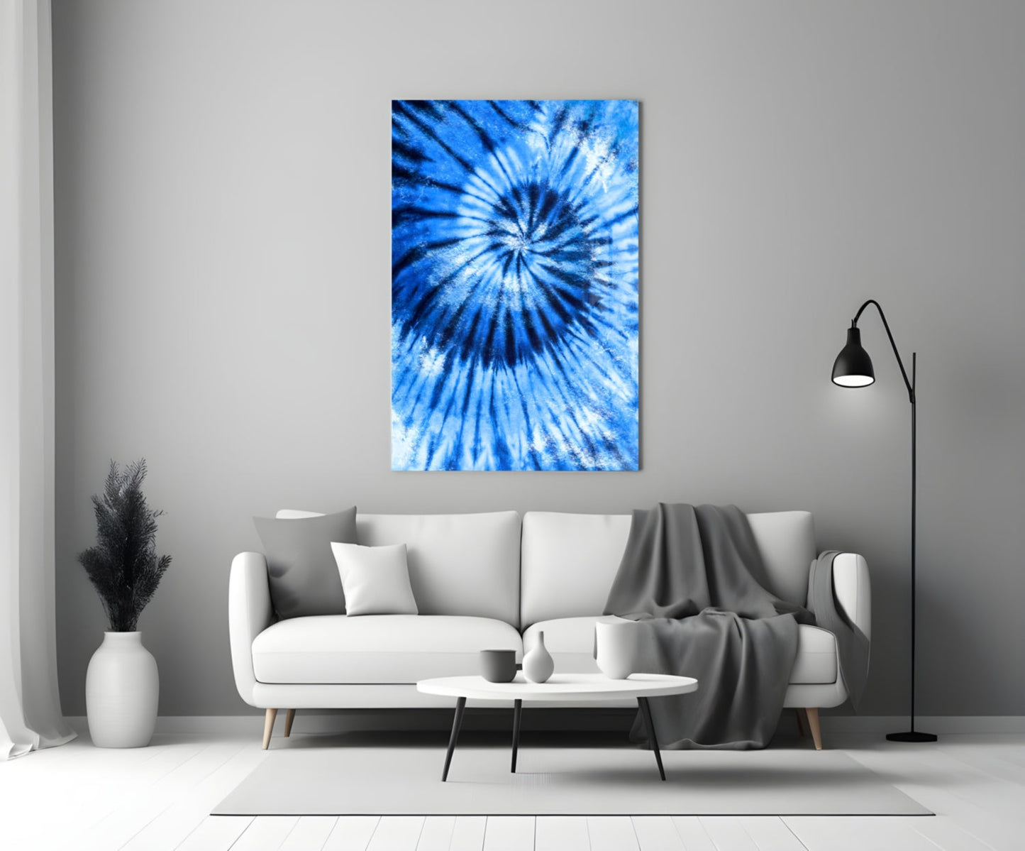 Blue mosaic glass wall art with radial tie-dye pattern displayed above white sofa in modern living room.