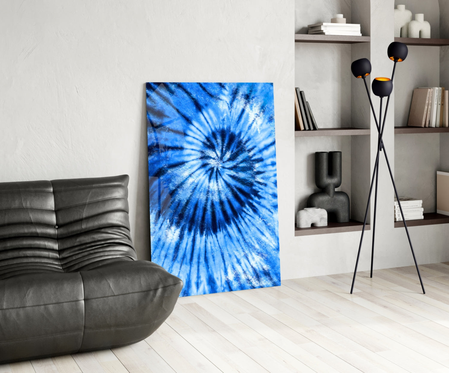 Blue mosaic glass wall art with radial starburst pattern displayed in modern living room setting with leather chair and shelving.