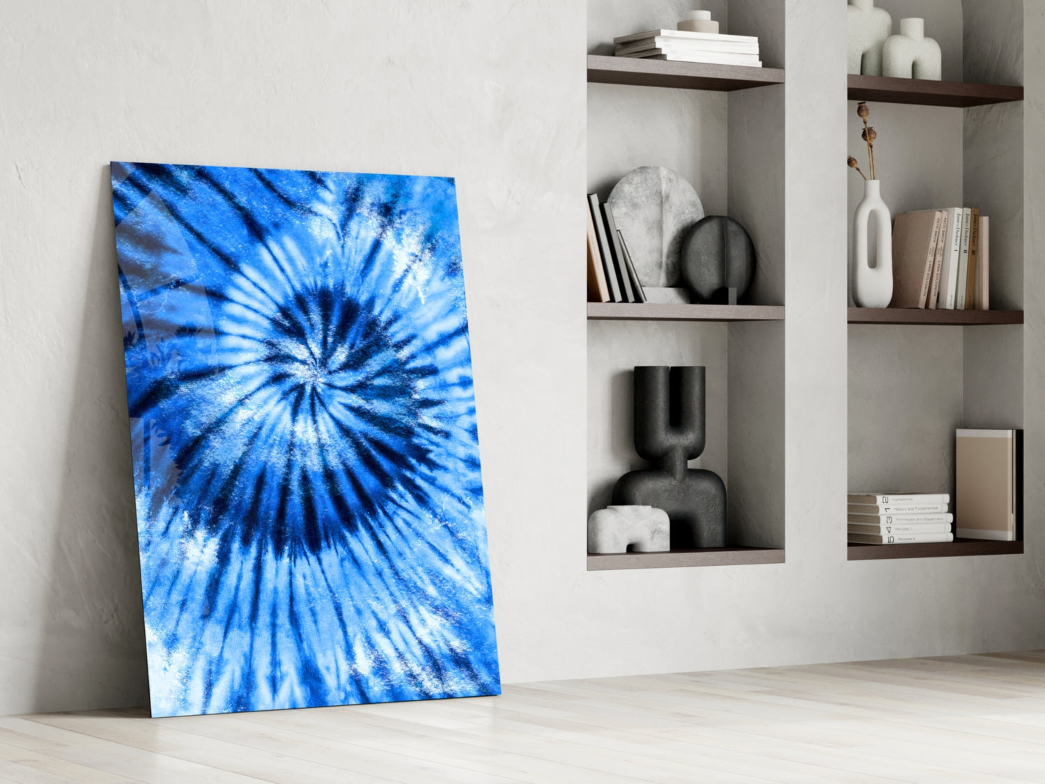 Blue tie-dye mosaic glass panel leaning against white wall beside shelving with decorative objects.