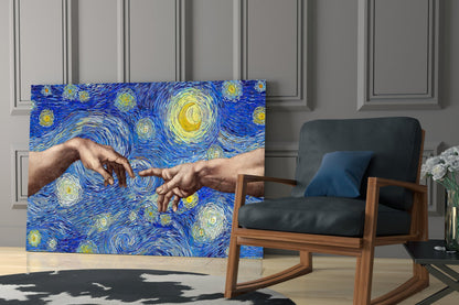 Glass wall art displaying two hands reaching toward each other against blue starry background, displayed in modern living room with wooden chair.