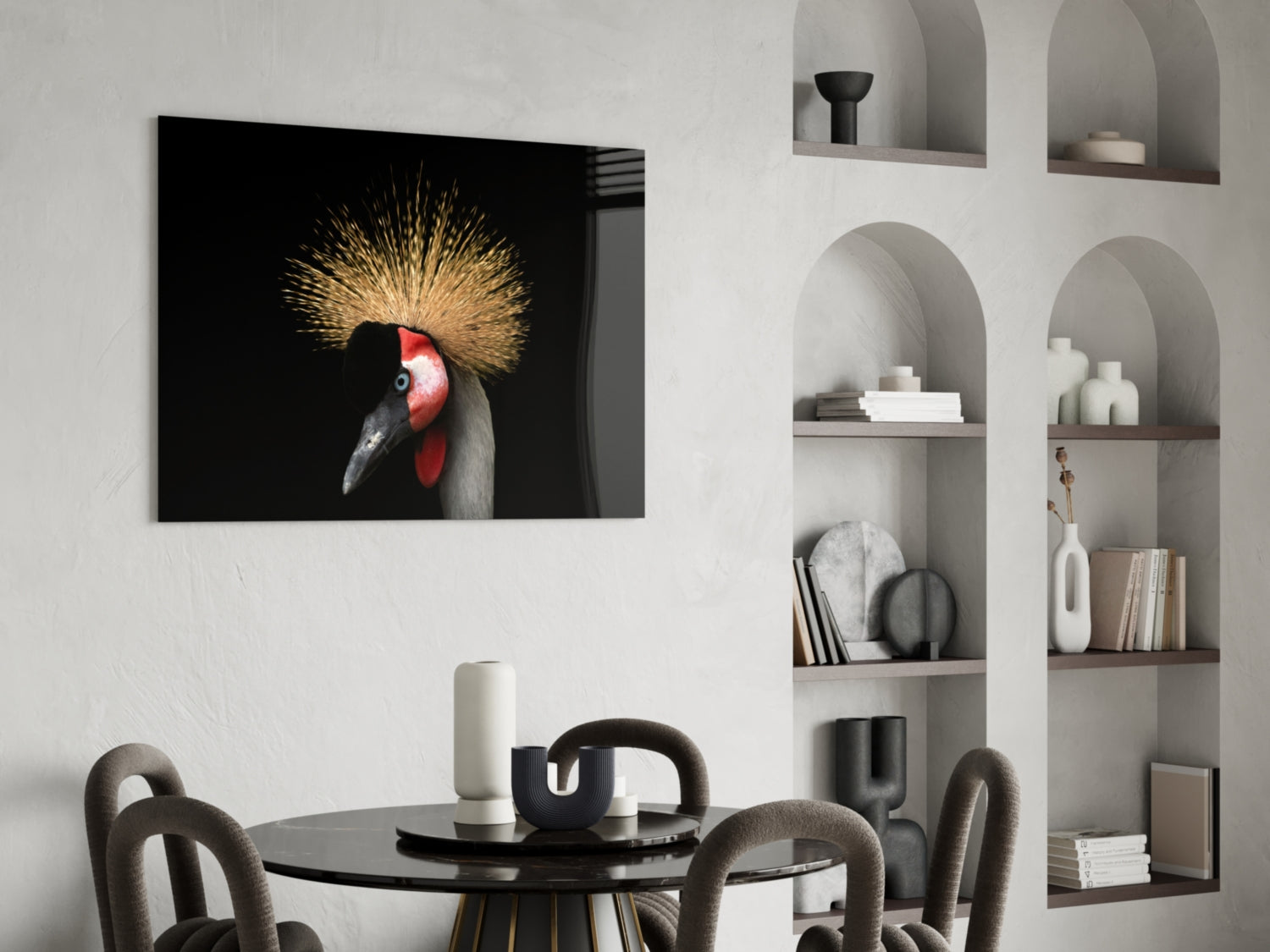 Glass wall art featuring crowned crane with golden crest and red face on black background, displayed above black dining table in modern interior.
