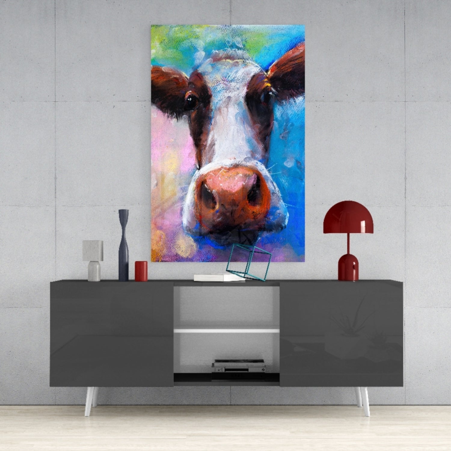 Colorful cow glass wall art displayed above a gray console table with decorative accessories and a red lamp.