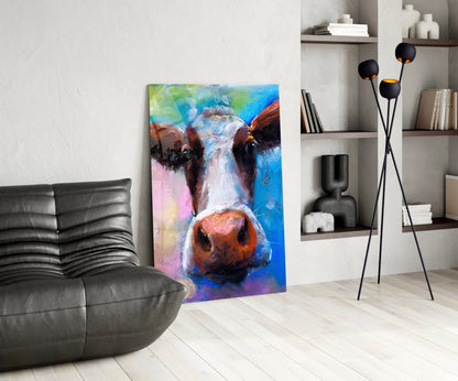 Colorful glass cow portrait artwork displayed in modern living room with gray sofa, black floor lamp, and white shelving.