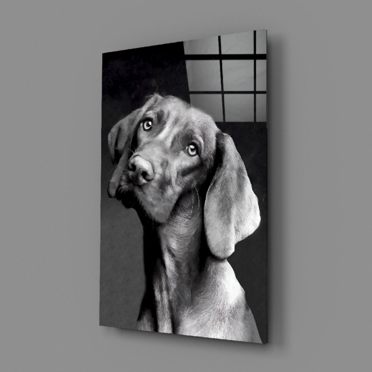 Black and white portrait of a dog with floppy ears tilting its head, printed on glass panel with grid pattern overlay.