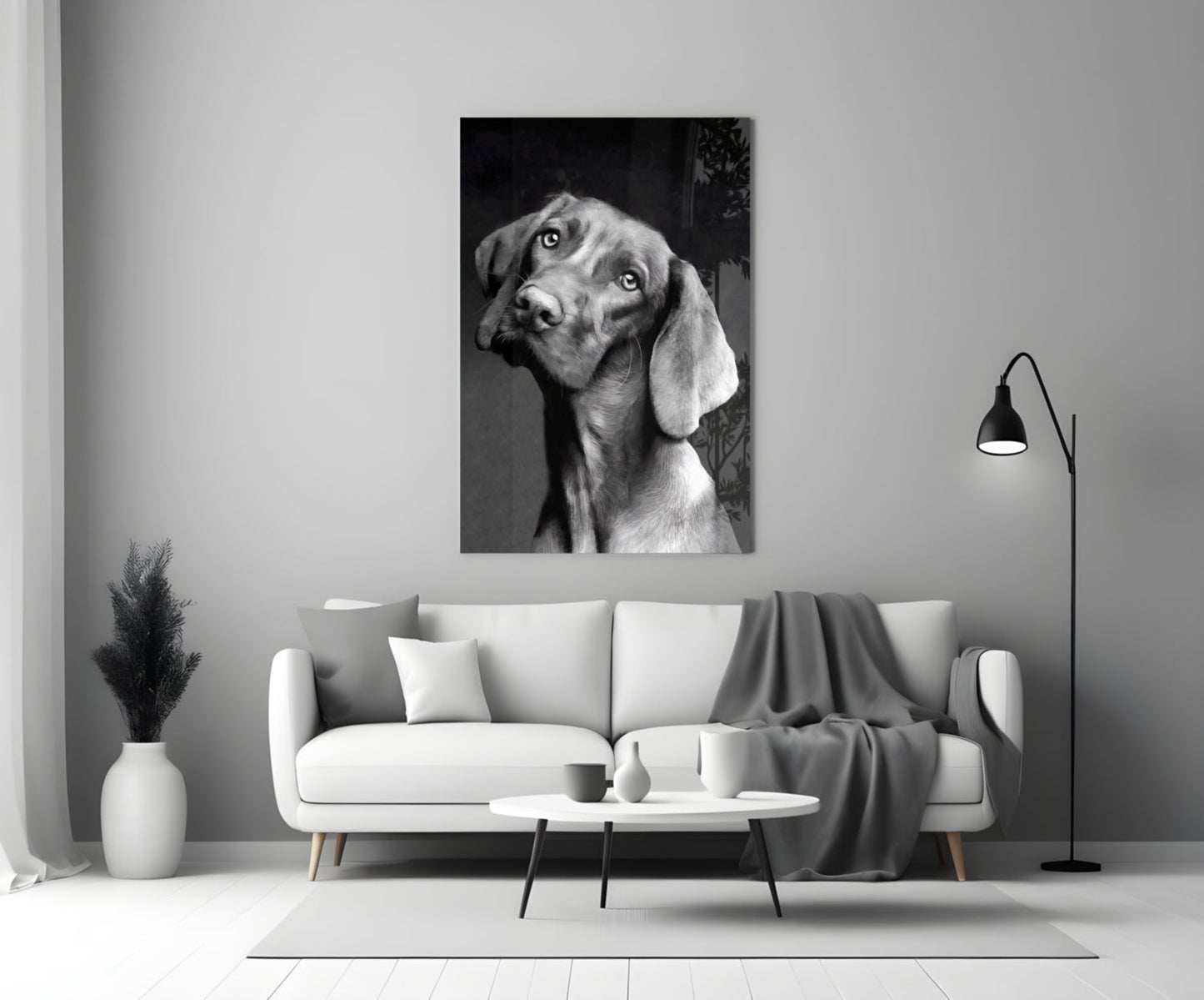 Black and white dog portrait glass wall art displayed above a white sofa in a modern living room setting.