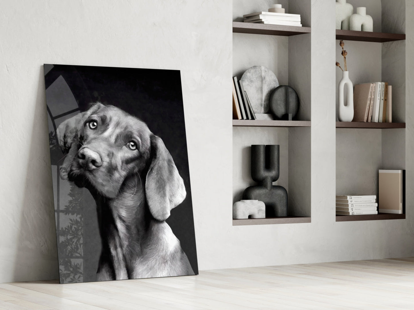 Black and white dog portrait glass wall art leaning against white wall beside wooden shelving unit.